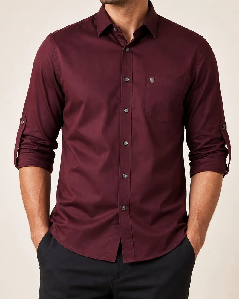 Man wearing a burgundy Musketeer long-sleeve cotton travel work button-down shirt with rolled sleeves